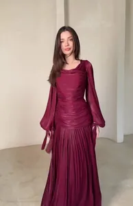 Elegant burgundy long-sleeve maxi dress with ruched bodice and pleated flowing skirt.