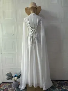 Elegant white floor-length dress with dramatic cape sleeves and a lace-up back detail