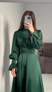 Elegant emerald green satin long-sleeved dress with high neck and ruffled cuffs detail