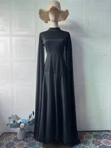 Elegant black maxi dress with dramatic long flared sleeves shown on a mannequin