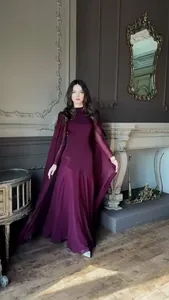 Full-length view of elegant deep purple maxi dress with dramatic flowing cape sleeves.