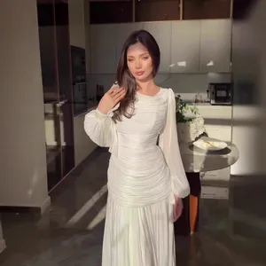 Elegant white French style ruched maxi dress with long sleeves in a sunlit kitchen