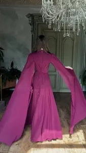 Elegant magenta maxi dress with dramatic cape sleeves and corset lace-up back design.