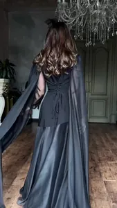 Back detail of elegant black maxi dress featuring corset lacing and sheer cape sleeves