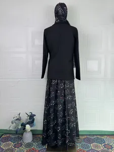 Back view of elegant three-piece modest set with black top and floral maxi skirt
