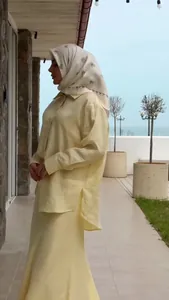 Elegant pale yellow modest long-sleeve shirt and matching skirt set for women outdoors