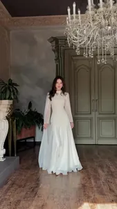 Elegant white long-sleeved maxi dress for formal occasions, full length professional view.