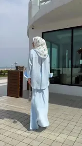 Elegant light blue long-sleeved top and maxi skirt set, rear view showing a loose, flowing fit.