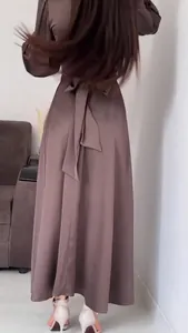 Detailed back view of brown satin long sleeve maxi dress with waist tie and bow detail