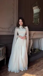 Elegant ivory long-sleeved maxi dress with cape sleeves for formal evening occasions
