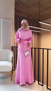 Elegant modest pink long-sleeve shirt and maxi skirt set for a graceful summer look.