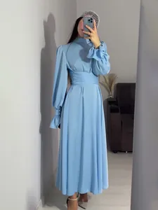Elegant light blue long sleeve maxi dress featuring puff sleeves and a waist wrap belt