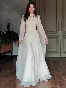 Elegant white long-sleeved evening gown with sheer sleeves for a graceful look.