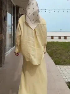 Elegant pale yellow long-sleeve shirt and maxi skirt set for summer vacation style