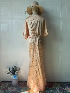 Vista posteriore di un elegante abito lungo in raso a fiori con stampa vintage