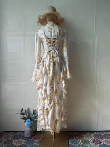 Back view of an elegant floral maxi dress with ruffle details and lace-up design.