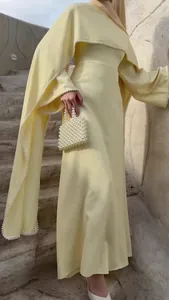 Elegantes blassgelbes Maxikleid mit perlenbesetztem Cape und langen Ärmeln für Damen.