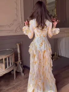 Elegant vintage floral print long-sleeved maxi dress featuring ruffles and a lace-up back design