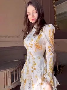 Elegant long-sleeved slim-fit maxi dress with yellow floral print in a vintage room