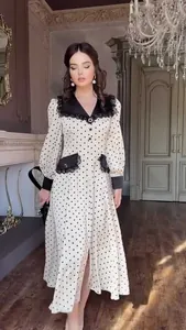 Elegant polka dot dress featuring a black lace-trimmed doll collar and long sleeves
