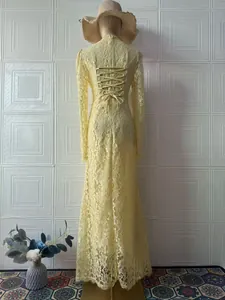 Detailed back view of a yellow Victorian lace maxi dress with lace-up corset design