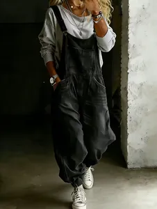 Full body view of stylish women's vintage loose black denim overalls with pockets