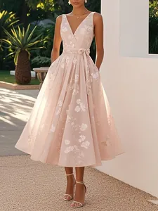 Detailed view of elegant pink floral sleeveless V-neck evening gown with a belted waist.
