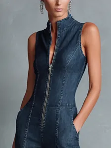 Detailed close-up of a vintage dark blue sleeveless denim jumpsuit with front zipper