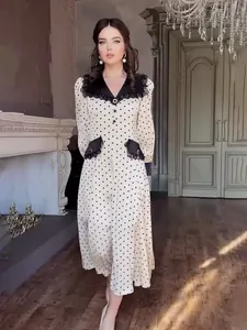 Elegant white polka dot midi dress with lace doll collar and black accents.
