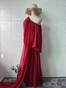 Full view of elegant red one-shoulder pleated gown featuring a long flowing train design