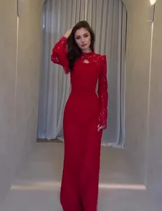 Close-up of elegant red lace long-sleeved evening dress with Victorian neck detail