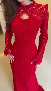 Close-up view of elegant red lace Victorian-style long-sleeved maxi evening dress gown.