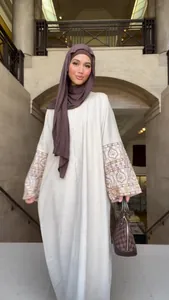Detailed view of a retro bohemian long dress featuring intricate patterns on sleeves