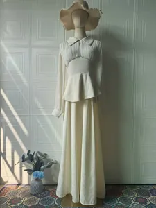Elegant long-sleeved maxi dress with pleated bodice and high-waisted ruffled detail