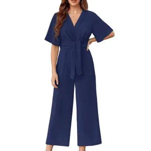 Front view of a navy blue V-neck short sleeve jumpsuit with elegant waist tie detail