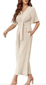 Elegant cream V-neck jumpsuit featuring short flutter sleeves and a chic tie-waist detail.