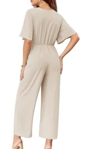 Rear view detail of a chic beige short-sleeve jumpsuit with elastic waist and wide legs