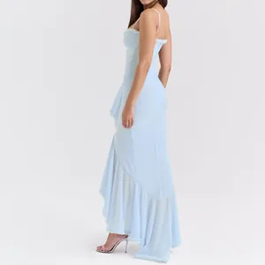 Detailed view of an elegant light blue spaghetti strap maxi dress with ruffled mesh hemline