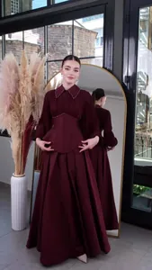 Elegant floor-length burgundy dress featuring beaded collar and pleated long sleeves detail