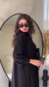 Elegant black long-sleeve maxi dress featuring chic button shoulder detail on model
