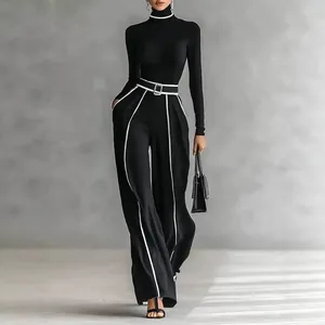 Elegant women's black two-piece set with turtleneck top and white-striped wide-leg pants.