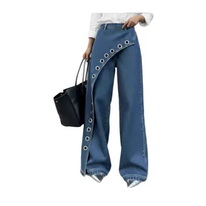 Detailed view of high-waisted blue wide-leg denim pants featuring unique diagonal grommet flap