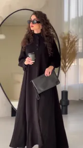 Elegantly styled black long-sleeved maxi dress for sophisticated street fashion