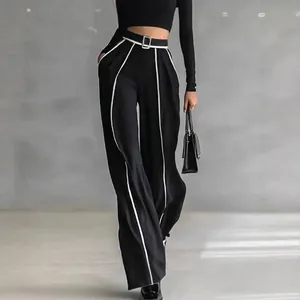 High-waisted black wide-leg trousers with white side stripes and matching crop top
