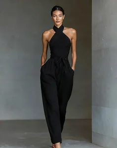 Sophisticated black halter neck wide-leg jumpsuit featuring a stylish waist tie