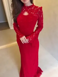Elegant red lace Victorian style long sleeve evening gown for formal occasions.