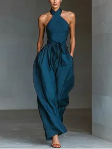 Elegant dark teal linen halter-neck jumpsuit with wide-leg design and waist tie