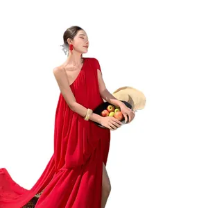 Elegant red one-shoulder pleated maxi dress with a flowing train for holiday photoshoots.