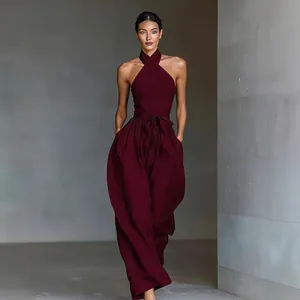 Elegant burgundy halter neck wide leg jumpsuit with waist tie and pockets for women.