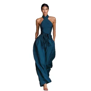 Elegant teal linen halter-neck wide-leg jumpsuit for women, perfect for summer.